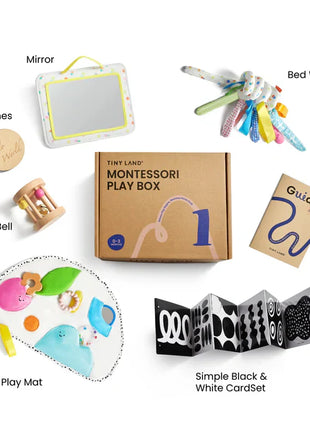 Flat lay of Tiny Land® Montessori Complete Baby Set (0-24 months) items arranged by the labeled box: mirror, bed wrap, parent’s guide, rolling bell for fine motor skills, colorful play mat pieces, milestone marker, and fold-out black & white cards.