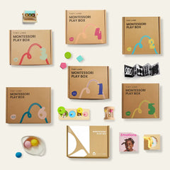 A flat lay of the Tiny Land® Montessori Complete Baby Set (0-24 months) with numbers, colorful designs, wooden toys, sensory items, the “Emotions” book, and more tools that promote fine motor skills and early learning.