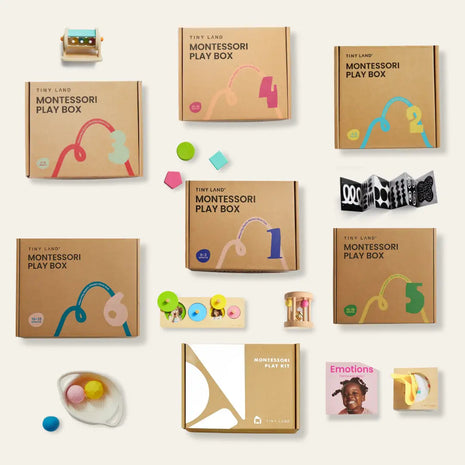 A flat lay of the Tiny Land® Montessori Complete Baby Set (0-24 months) with numbers, colorful designs, wooden toys, sensory items, the “Emotions” book, and more tools that promote fine motor skills and early learning.