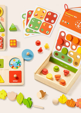 The Tiny Land® Montessori Complete Baby Set (0-24 months) features shape and season puzzles, pattern cards, pegs, blocks, stringing beads, and a booklet—ideal for sensory play and fine motor skill development on a light background.